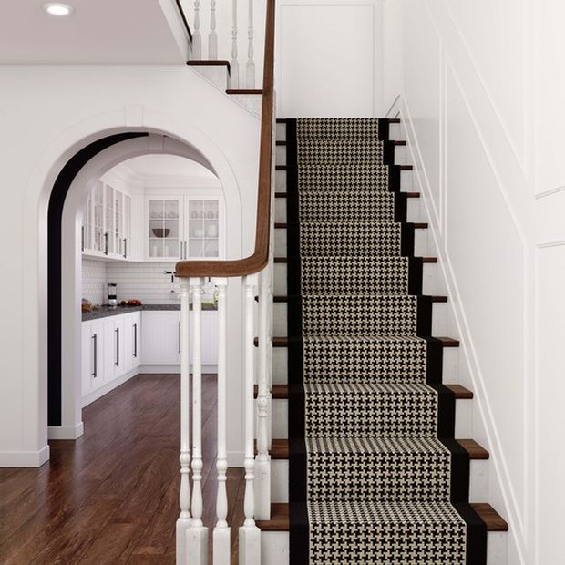 White staircase with natural wood finish and patterned stair runners