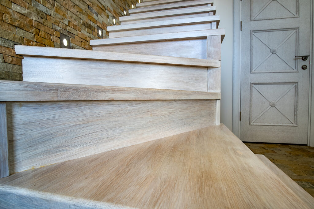 Stylish wooden contemporary staircase inside loft house interior.