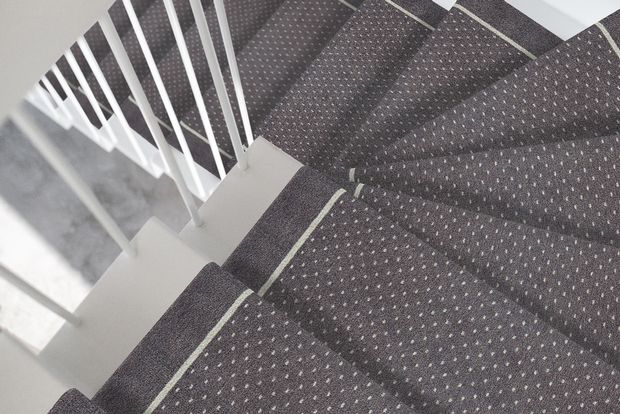 white staircase with grey stair runner
