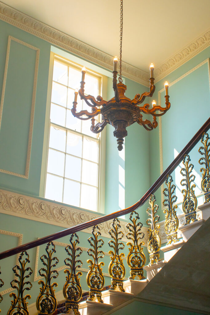 Georgian Stairway With Chandelier hanging from the ceiling