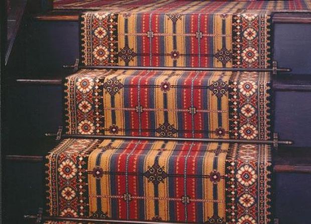 Antique runner rod on an exquisite-patterned stair runner