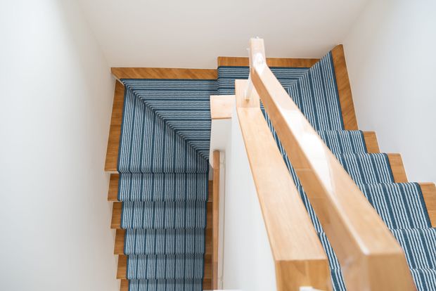 wooden stairs with a colourful blue stair runner