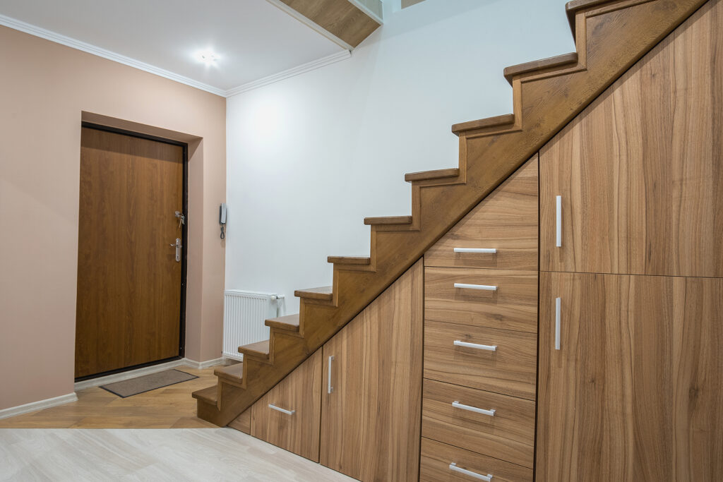 wooden staircase with a spandrel cupboard