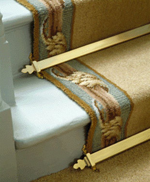 brass stair rods holding a runner in place