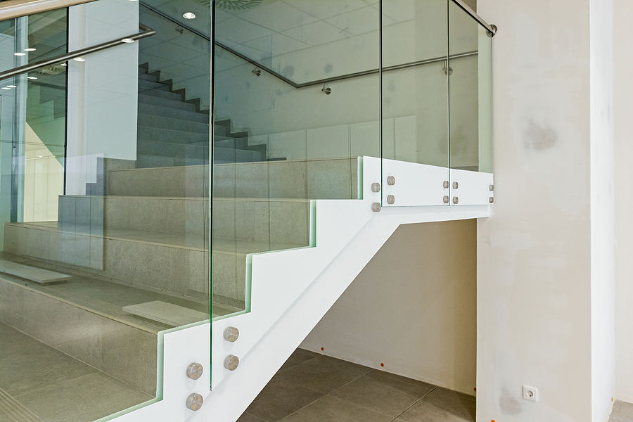 Detail on stairway with glass railing in a new modern building.