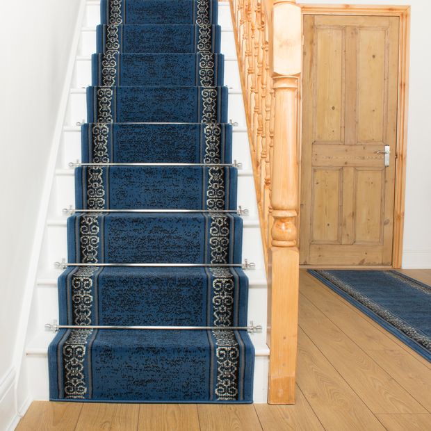 blue stair runner with gold and black designs on either side