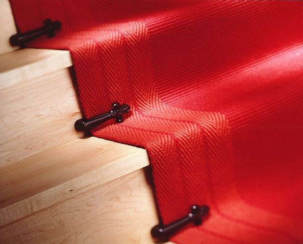 Victorial stair clips on red runner
