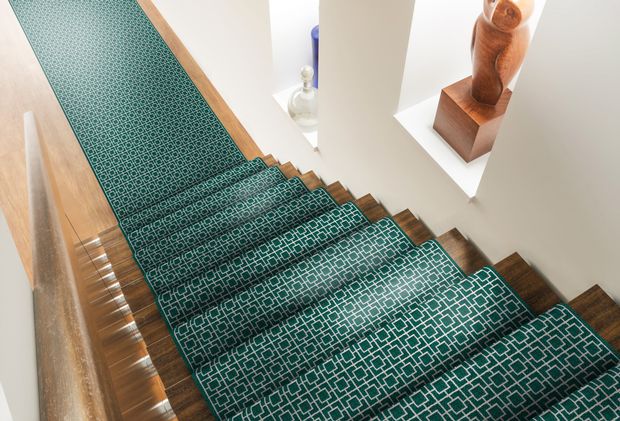 patterned stair runner on wooden stairs