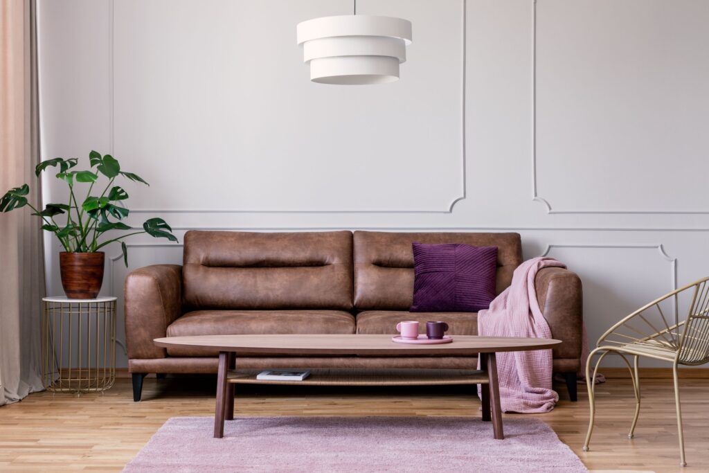 Wainscotting living room with brown leather sofa