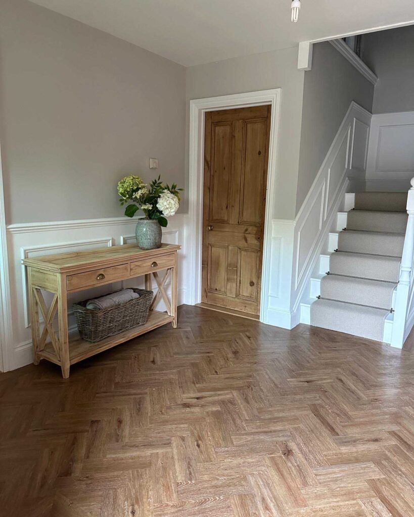 neutral hallway with wooden furniture 